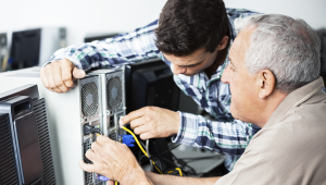 Computer Technician Helping Senior